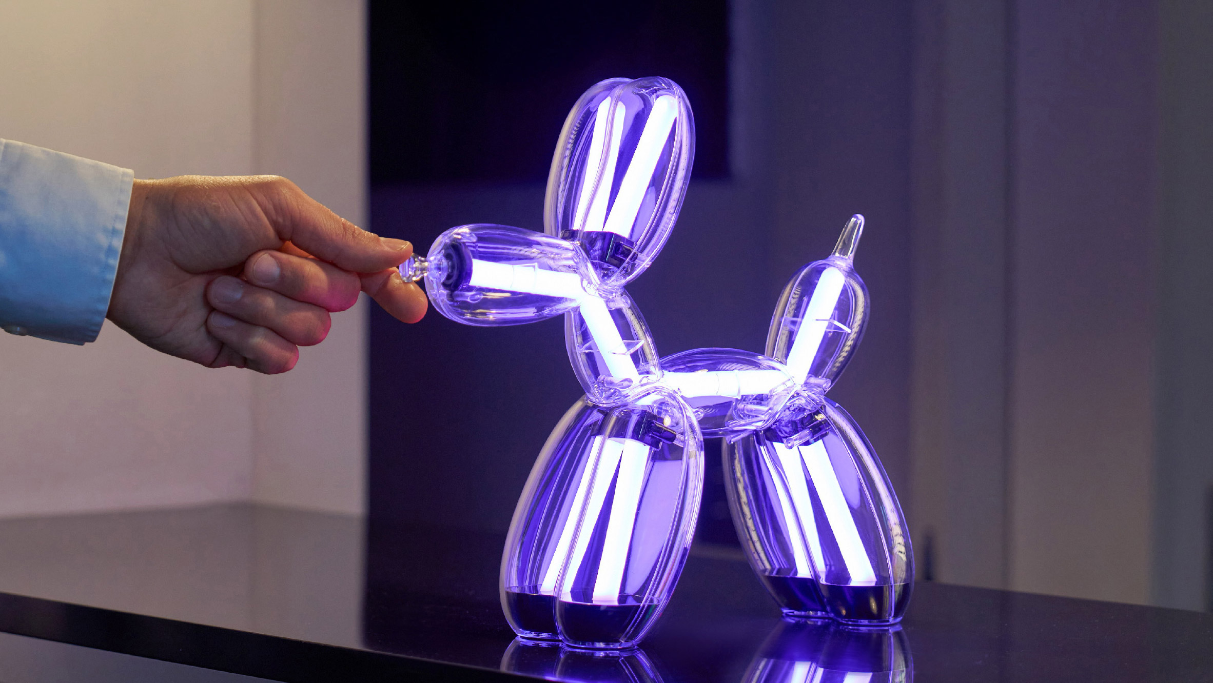 Illuminated Balloon Dog Lamp Chromatic in transparent gold polycarbonate, featuring integrated LED lighting and reflective sculptural form. Official Jeff Koons x Lexon collaboration, presented by Designooor Media and Academy. Written and edited by Hamed Mahzoon 