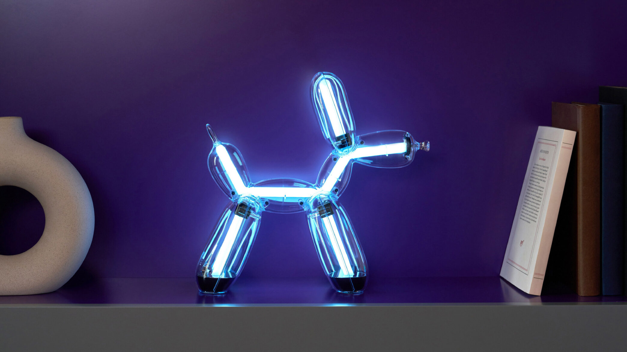Illuminated Balloon Dog Lamp Chromatic in transparent gold polycarbonate, featuring integrated LED lighting and reflective sculptural form. Official Jeff Koons x Lexon collaboration, presented by Designooor Media and Academy. Written and edited by Hamed Mahzoon