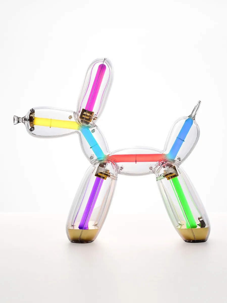 Illuminated Balloon Dog Lamp Chromatic in transparent gold polycarbonate, featuring integrated LED lighting and reflective sculptural form. Official Jeff Koons x Lexon collaboration, presented by Designooor Media and Academy. Written and edited by Hamed Mahzoon 